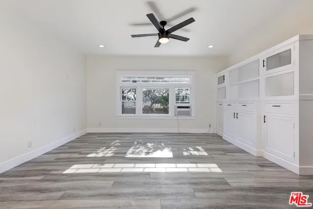 a view of a livingroom with a window and a ceiling fan