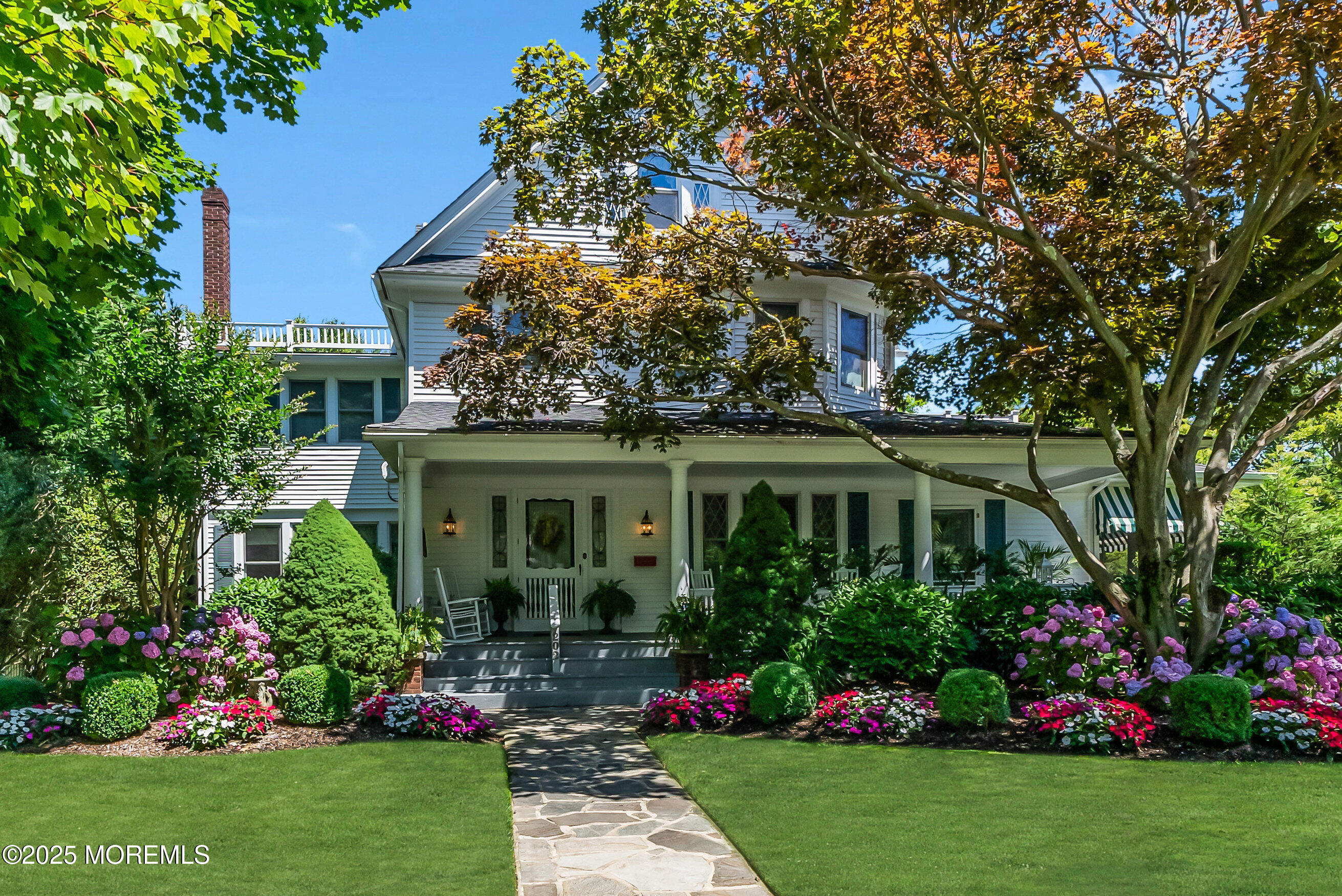 a view of a house with a big yard and potted plants