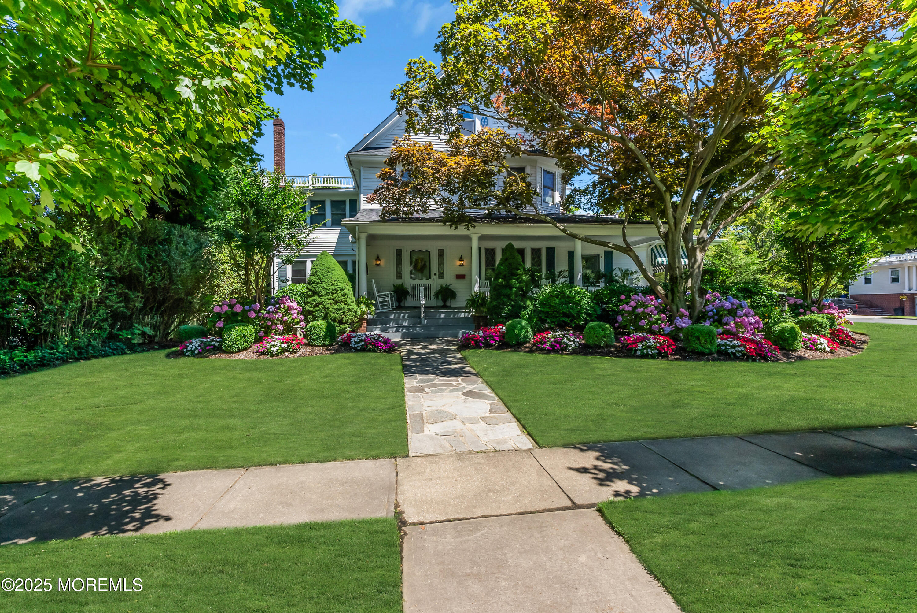 202 Ludlow Avenue Spring Lake, NJ 07762 - Photo 2 of 99 a front view of a house with a garden and plants
