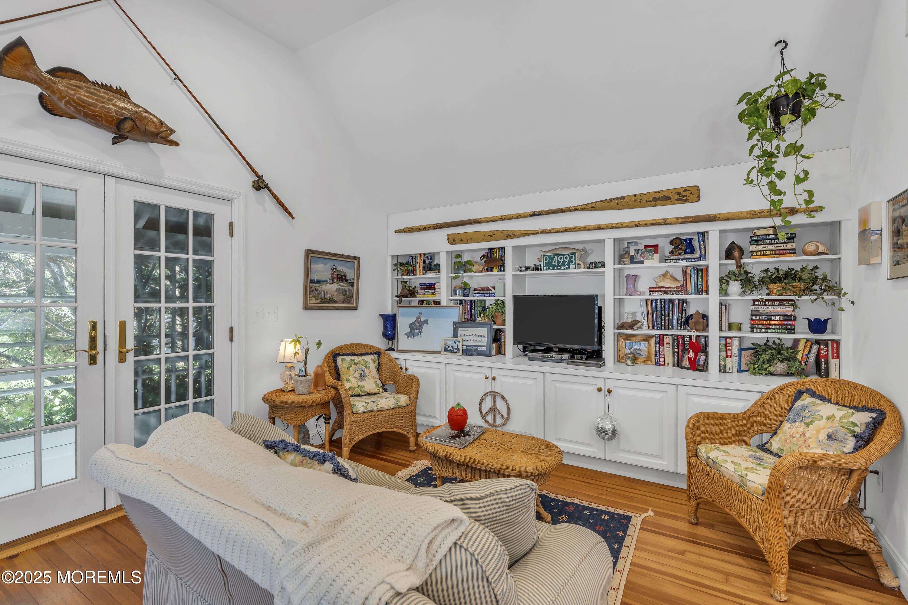 202 Ludlow Avenue Spring Lake, NJ 07762 - Photo 76 of 99 a living room with furniture a flat screen tv and a floor to ceiling window