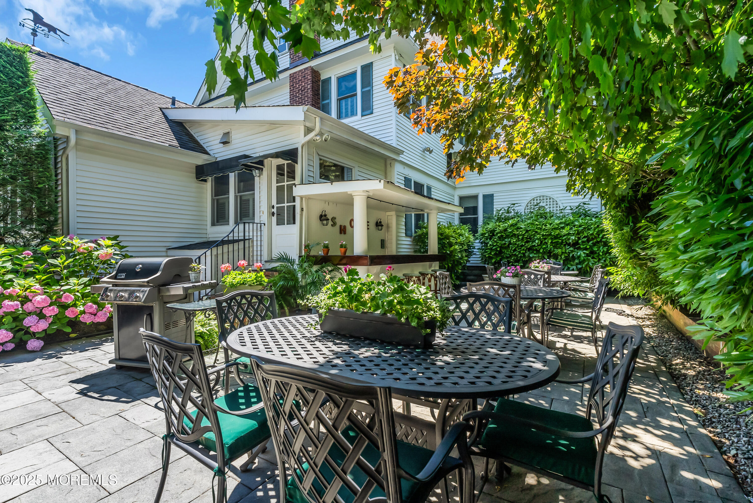 202 Ludlow Avenue Spring Lake, NJ 07762 - Photo 93 of 99 a view of a patio with table and chairs and potted plants