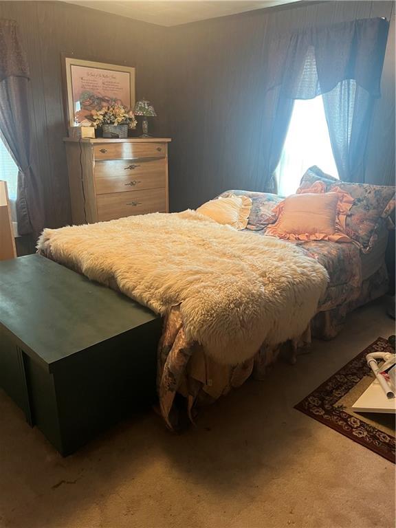 209-211 Old School Road Luxor, PA 15662 - Photo 17 of 27 a bed sitting in a bedroom next to a window