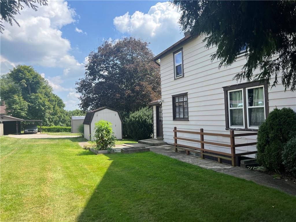 209-211 Old School Road Luxor, PA 15662 - Photo 3 of 27 a front view of a house with a garden and trees