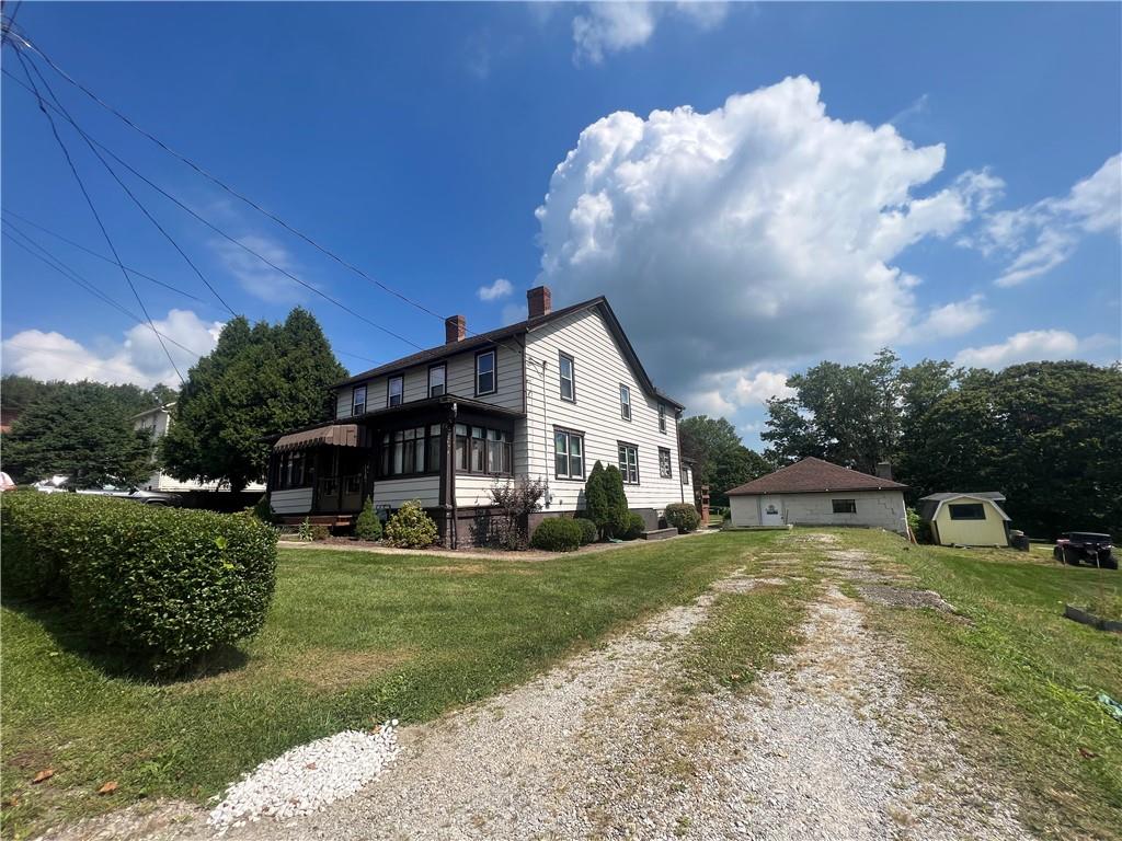 209-211 Old School Road Luxor, PA 15662 - Photo 4 of 27 a view of a house with a big yard and potted plants