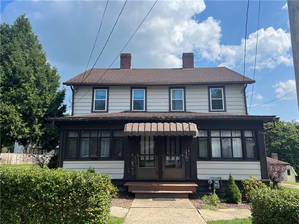 209-211 Old School Road Luxor, PA 15662 - Photo 5 of 27 a front view of a house with a yard