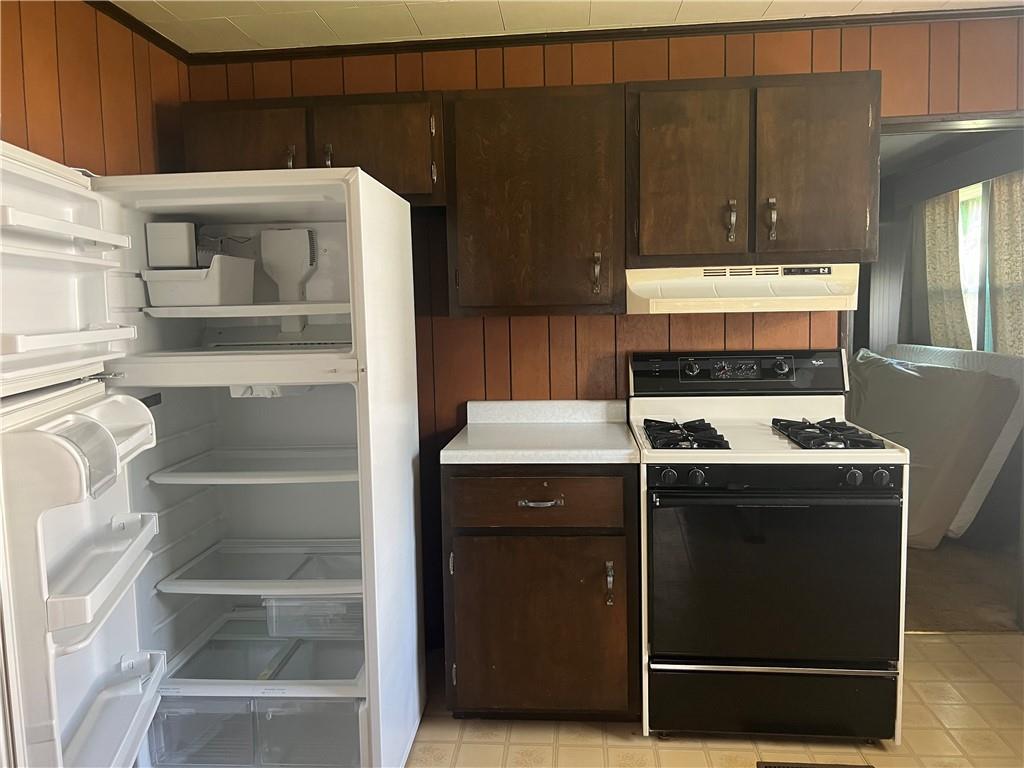 209-211 Old School Road Luxor, PA 15662 - Photo 9 of 27 a kitchen with a stove and a refrigerator