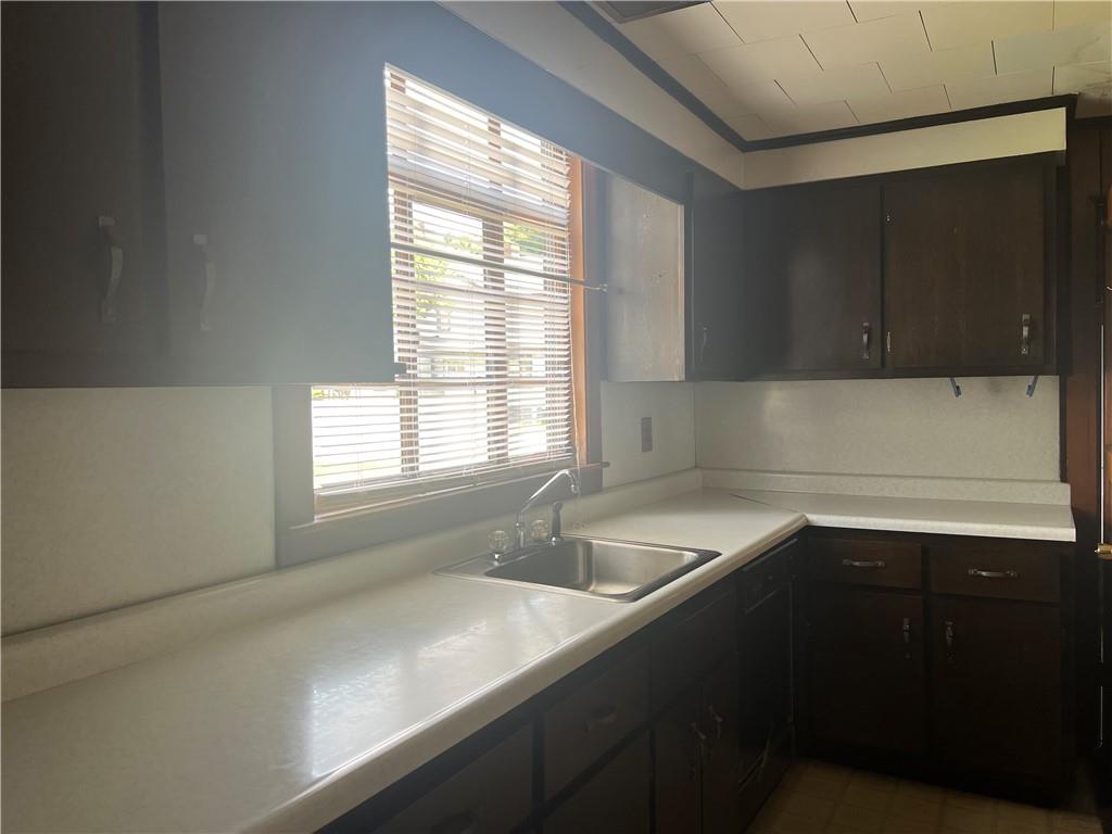 209-211 Old School Road Luxor, PA 15662 - Photo 10 of 27 a kitchen with a sink and a window