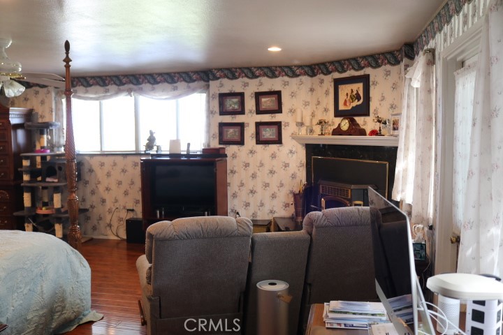 33975 Wright Road Wildomar, CA 92595 - Photo 30 of 70 a living room with furniture a fireplace and a large window