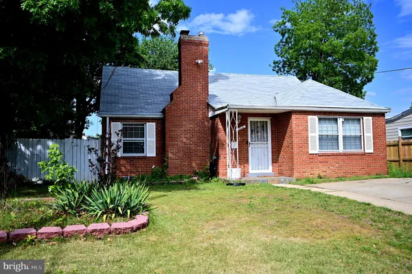 a front view of a house with a garden and plants