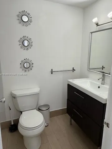 a bathroom with a sink vanity and mirror