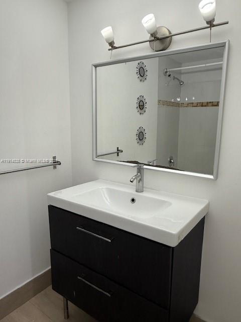 500 Bayview Drive, Unit 125 Sunny Isles Beach, FL 33160 - Photo 12 of 19 a bathroom with a sink vanity and mirror
