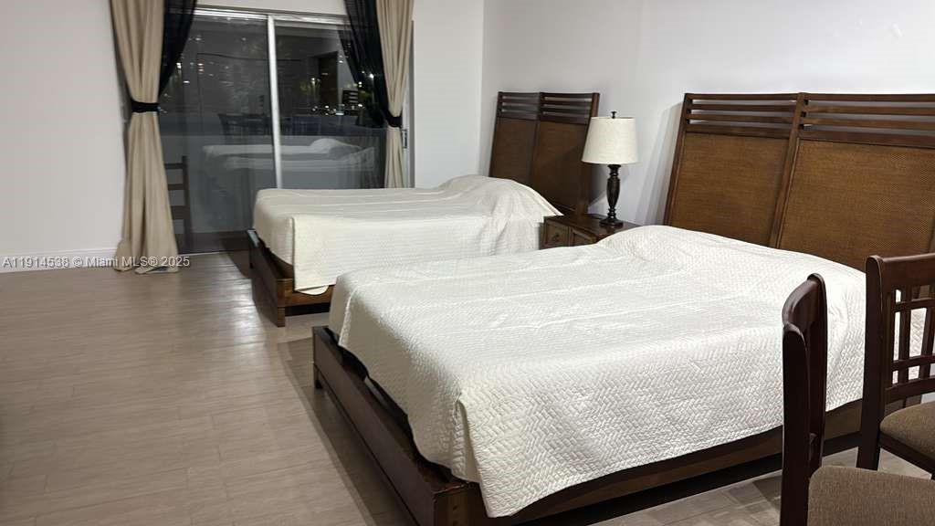 500 Bayview Drive, Unit 125 Sunny Isles Beach, FL 33160 - Photo 4 of 19 a bedroom with two beds and painted walls