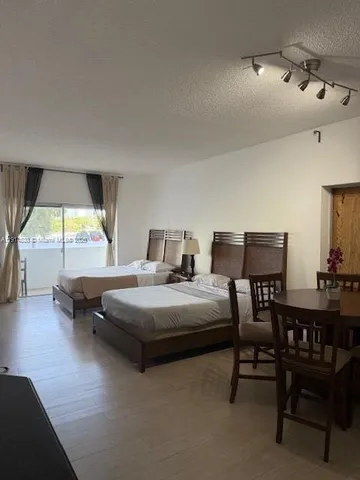 a bed room with two bed and a television