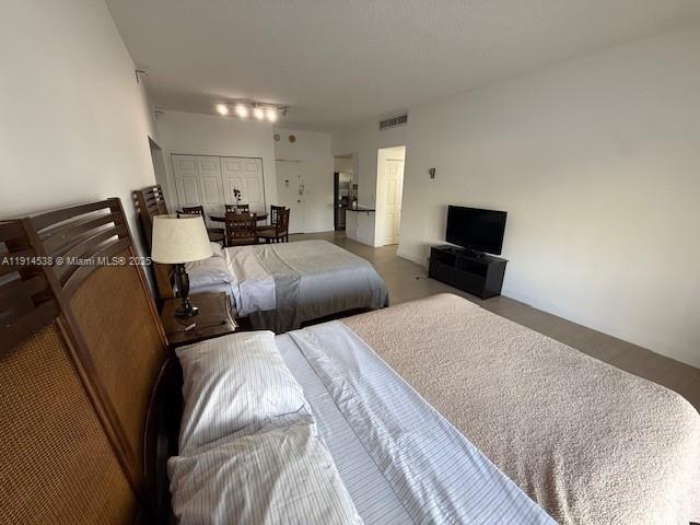 500 Bayview Drive, Unit 125 Sunny Isles Beach, FL 33160 - Photo 6 of 19 a bed room with two bed and a television
