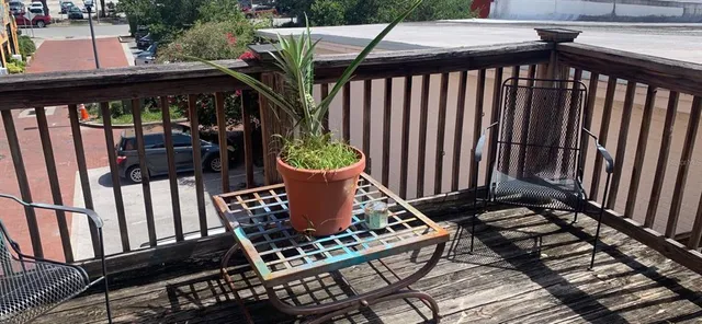 a view of a balcony with wooden floor