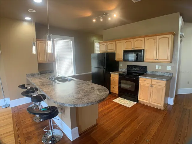 a kitchen with kitchen island stainless steel appliances a sink and stove