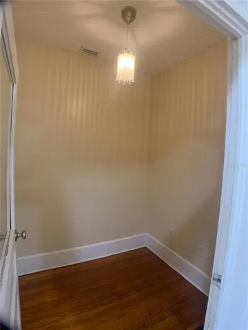 a view of a room with wooden floor and windows