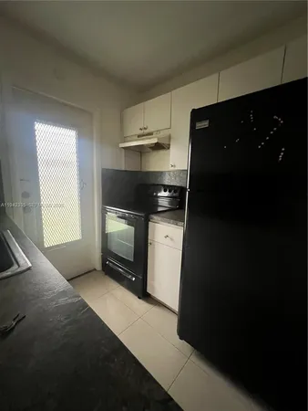 a kitchen with a stove and a refrigerator