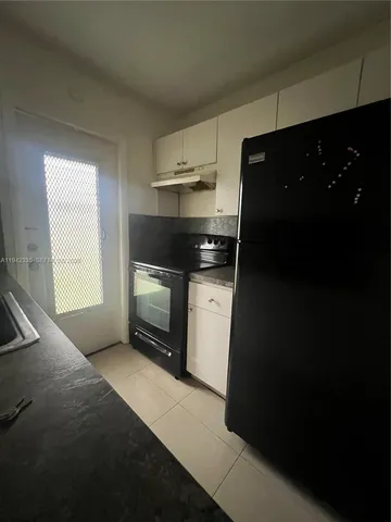 a kitchen with a stove and a refrigerator