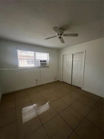 a view of an empty room and a window