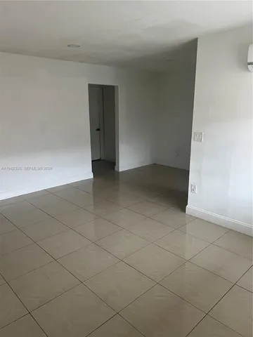 an empty room with a bench