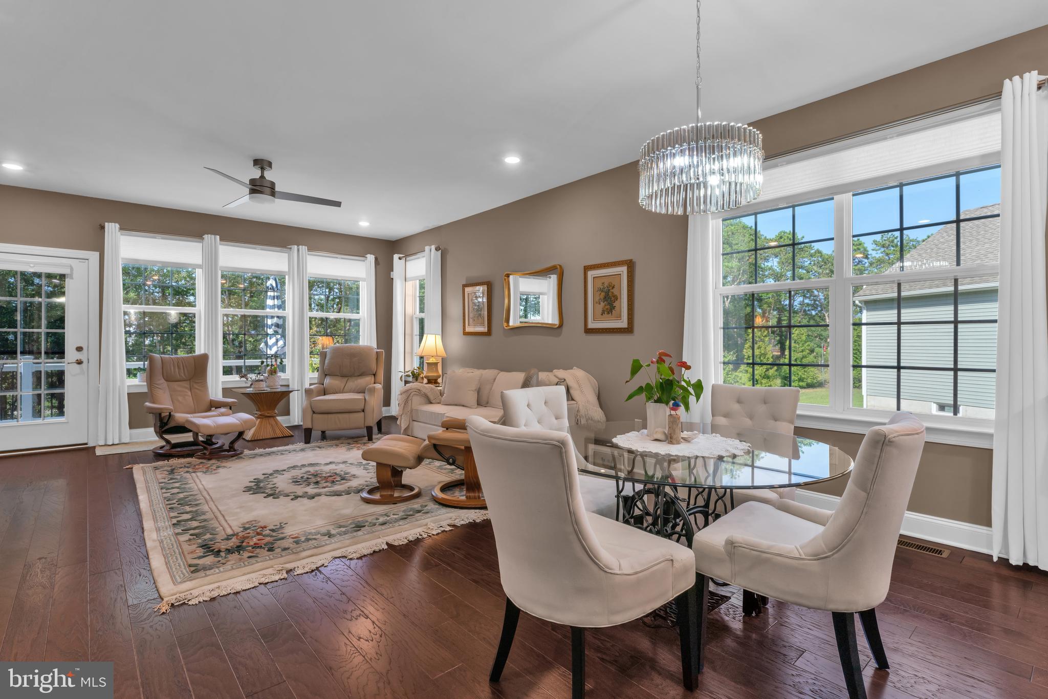 66 Butler Drive Barnegat, NJ 08005 - Photo 12 of 49 a view of a dining room with furniture large windows and wooden floor