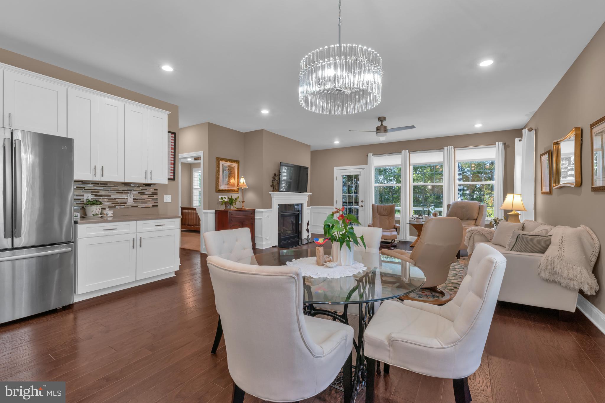 66 Butler Drive Barnegat, NJ 08005 - Photo 15 of 49 a view of a dining room with furniture a kitchen and chandelier