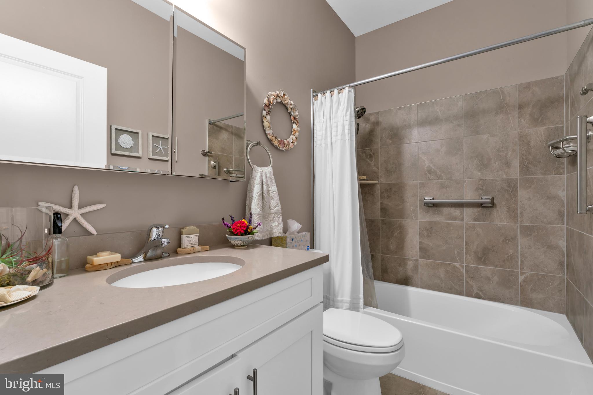 66 Butler Drive Barnegat, NJ 08005 - Photo 20 of 49 a bathroom with a sink vanity mirror toilet and bathtub