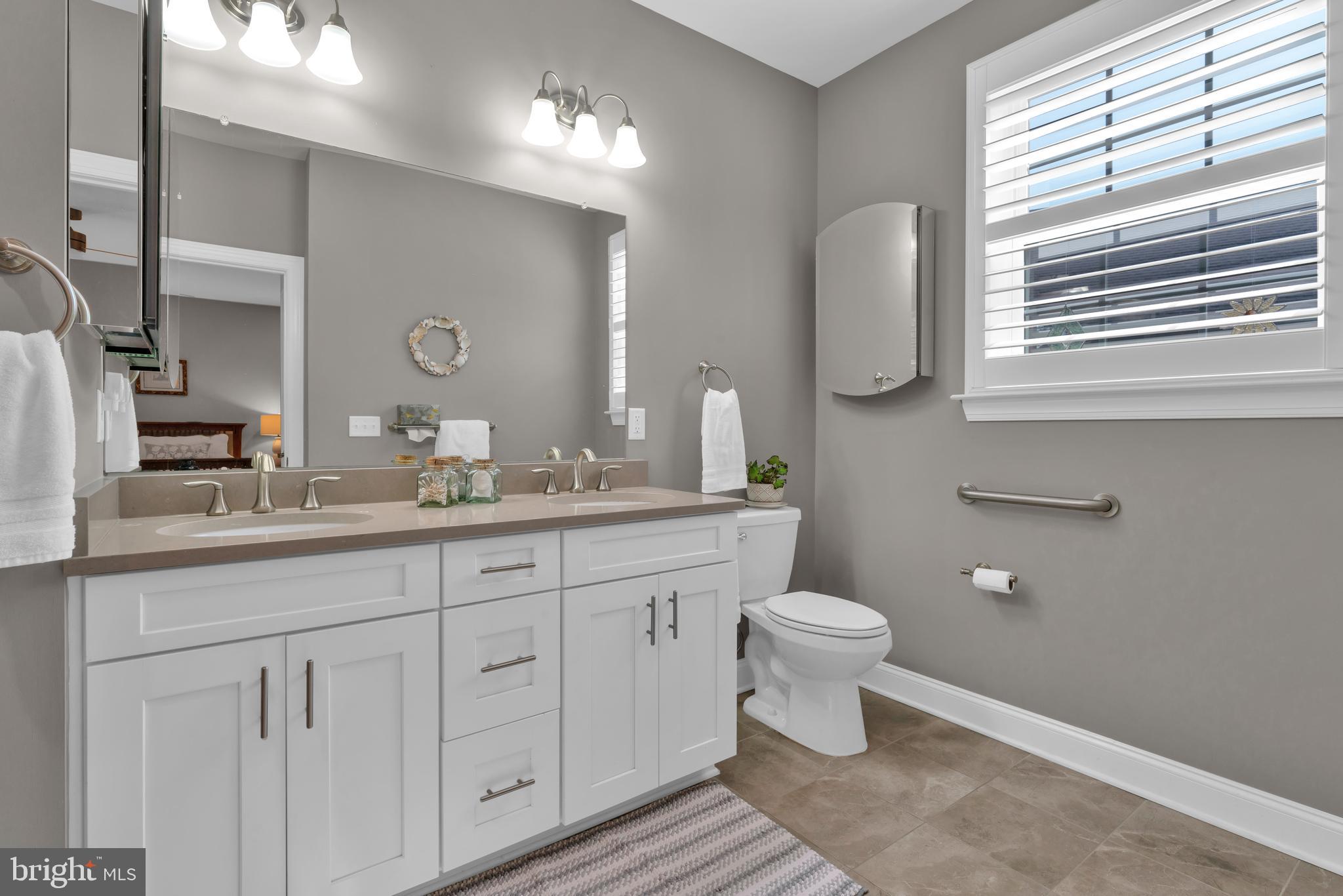 66 Butler Drive Barnegat, NJ 08005 - Photo 23 of 49 a bathroom with a toilet a sink and a window