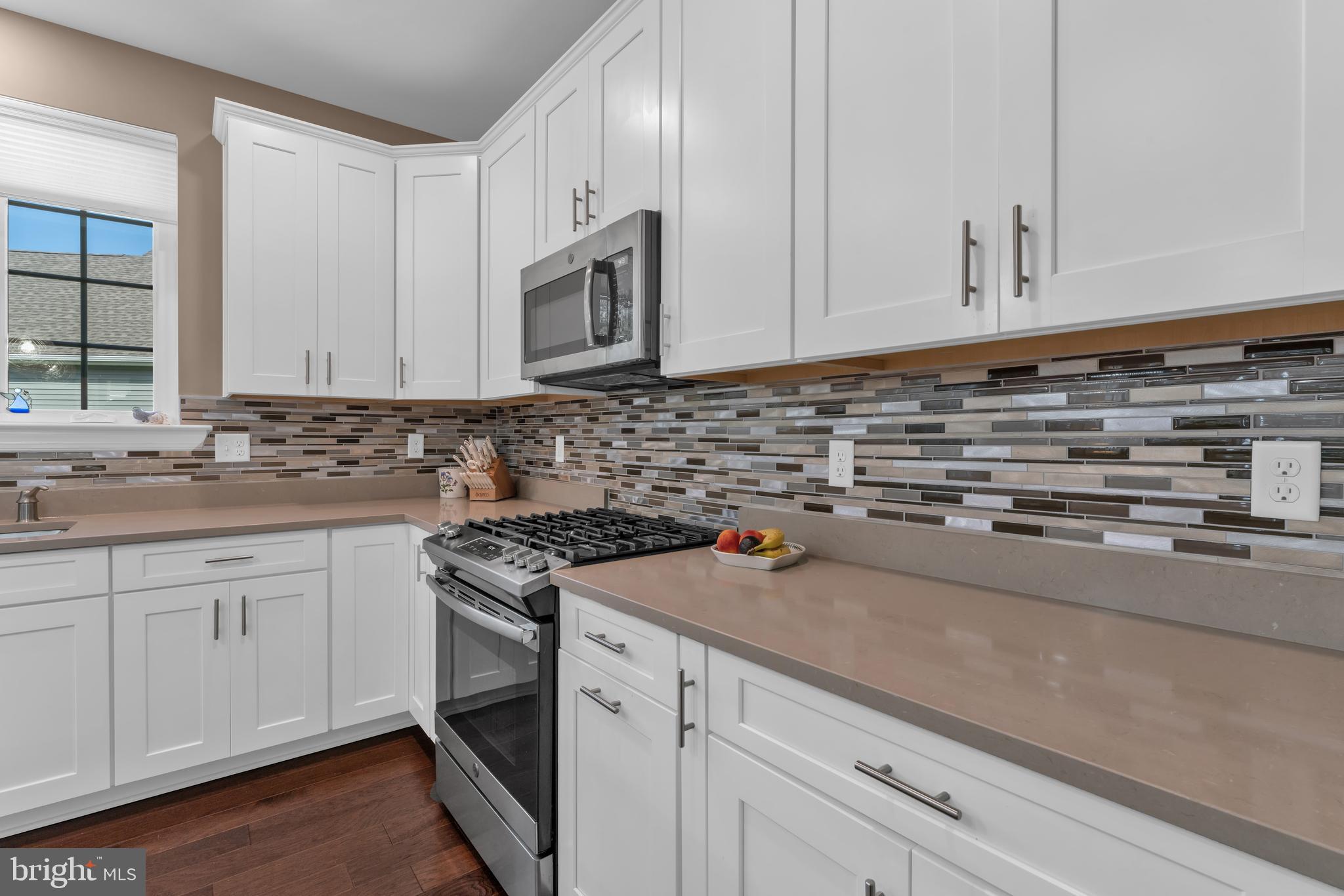 66 Butler Drive Barnegat, NJ 08005 - Photo 8 of 49 a kitchen with granite countertop white cabinets and white appliances