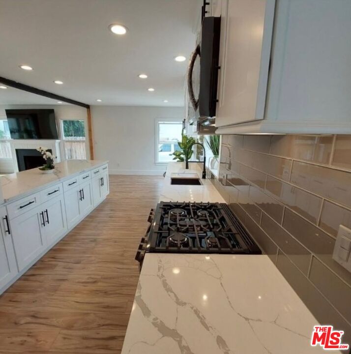 2560 Cotner Avenue Los Angeles, CA 90064 - Photo 19 of 20 a kitchen with stainless steel appliances a sink stove and cabinets