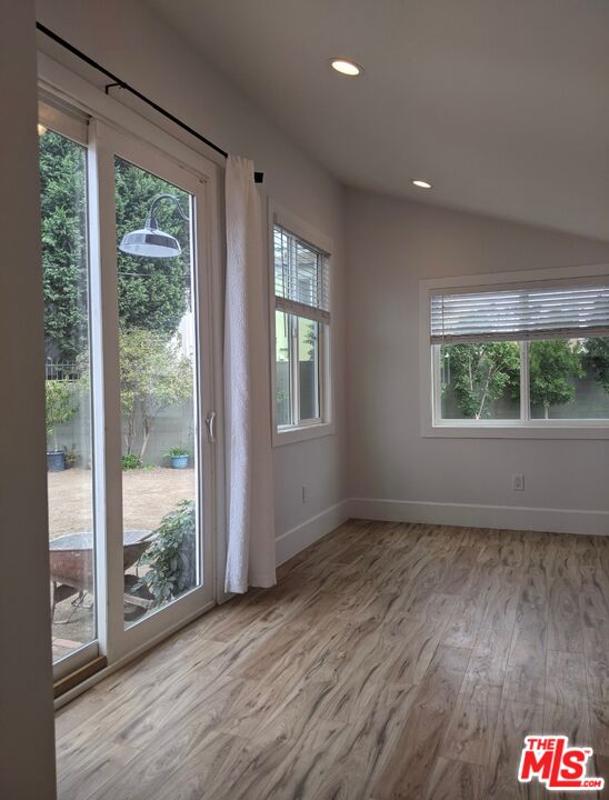 2560 Cotner Avenue Los Angeles, CA 90064 - Photo 20 of 20 a view of an empty room with wooden floor and windows