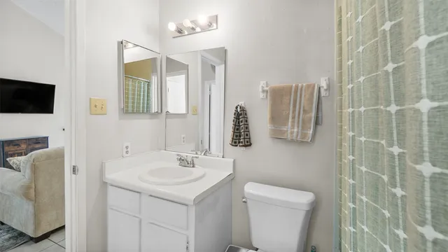 a bathroom with a sink a toilet and mirror