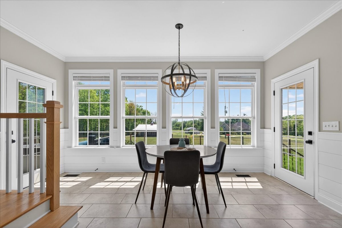 11039 Panther Creek Road Christiana, TN 37037 - Photo 17 of 76 a dining room with furniture a chandelier and glass door