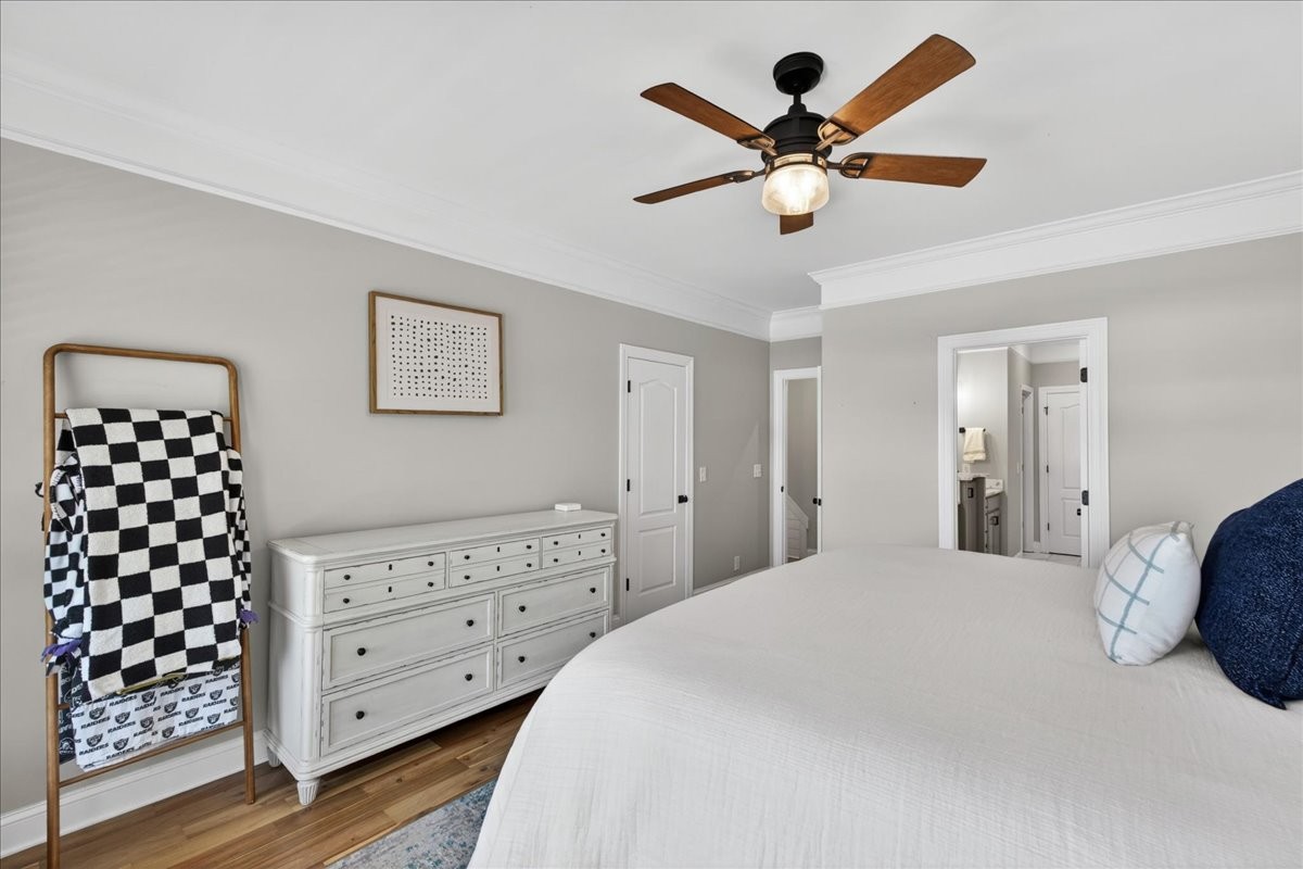 11039 Panther Creek Road Christiana, TN 37037 - Photo 23 of 76 a bedroom with a large bed and a chandelier