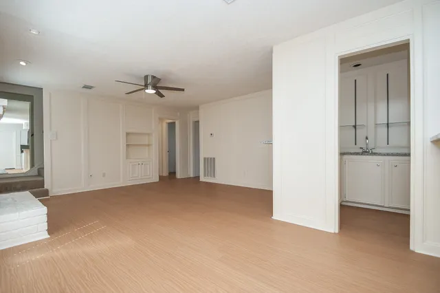 an empty room with a bathroom and a sink