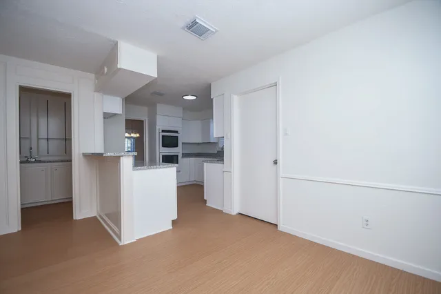 a view of kitchen with furniture and refrigerator