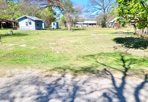 a view of walk in front of house with yard