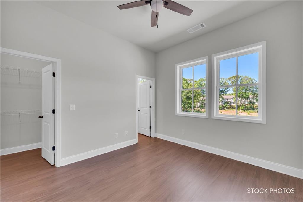 1038 Homestead Way Street Dacula, GA 30019 - Photo 16 of 36 a view of an empty room with wooden floor and a window