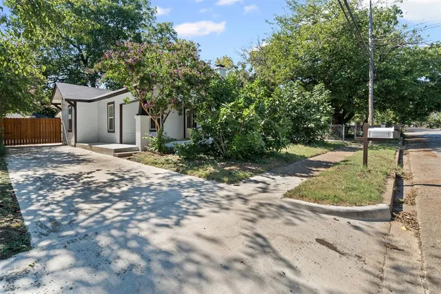 a backyard of a house with a yard and outdoor seating