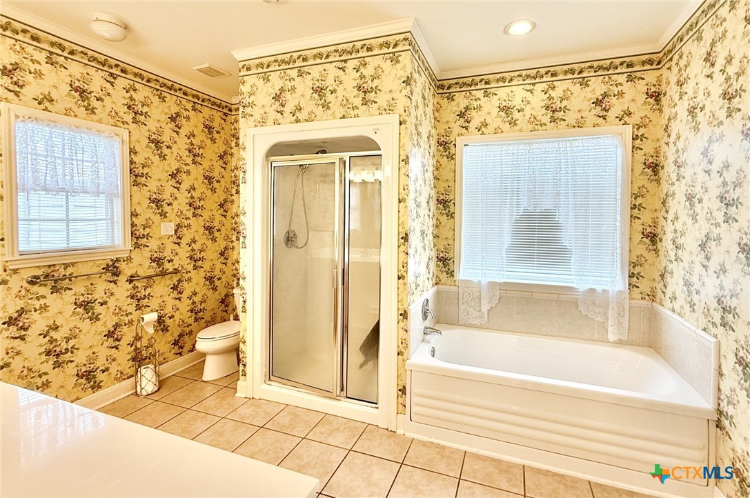 415 South Trinity Street Edna, TX 77957 - Photo 25 of 46 a bathroom with a bathtub and shower