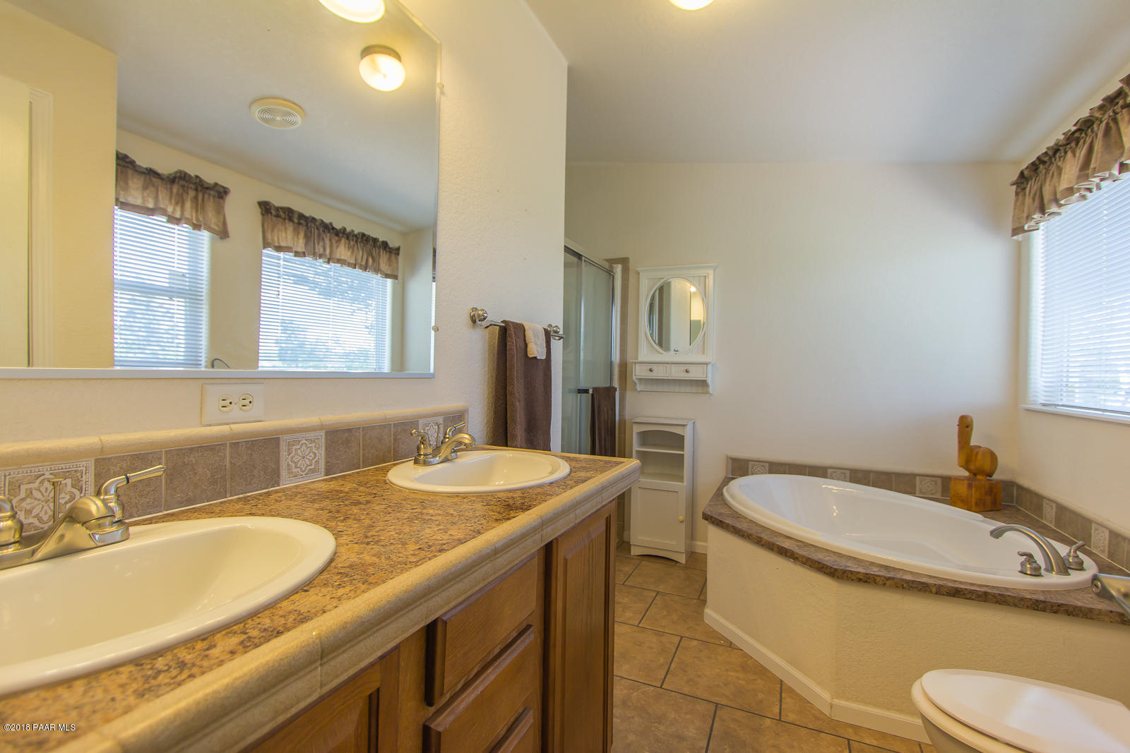 2691 North Reed Road Chino Valley, AZ 86323 - Photo 25 of 36 a bathroom with a granite countertop double vanity sink and a mirror