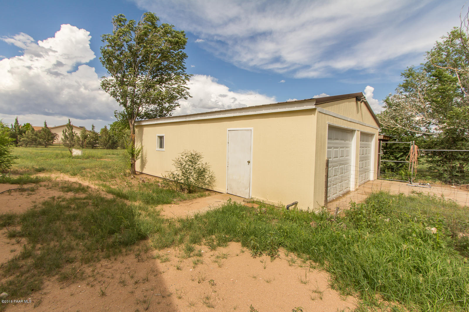 2691 North Reed Road Chino Valley, AZ 86323 - Photo 4 of 36 a backyard of a house with plants and trees