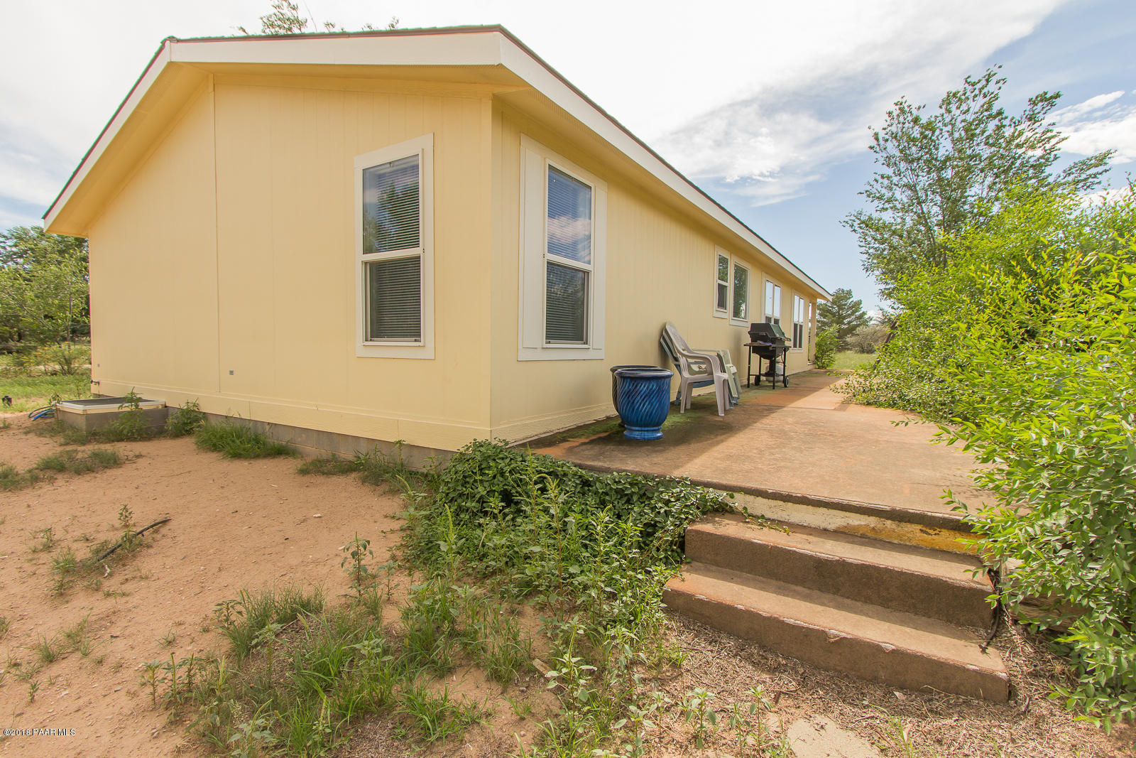 2691 North Reed Road Chino Valley, AZ 86323 - Photo 5 of 36 a front view of a house with a yard