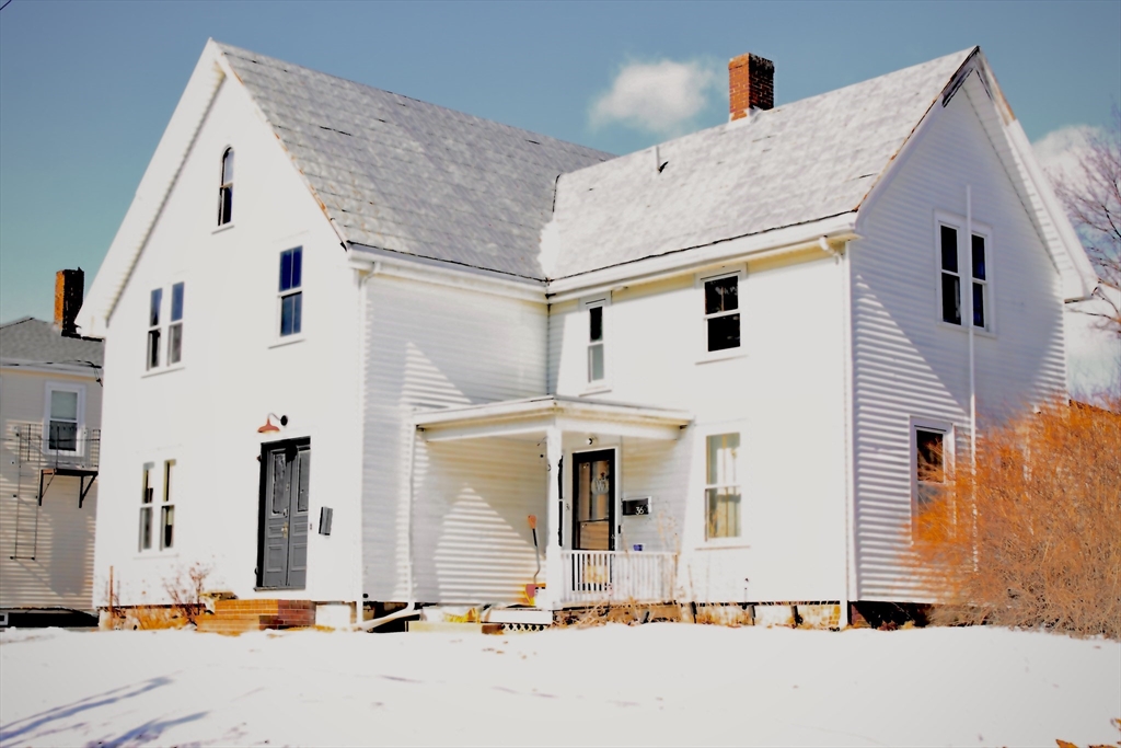 a front view of a house with large windows