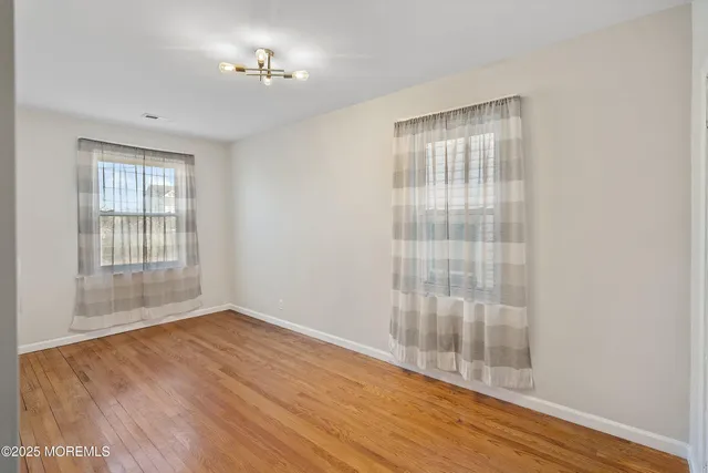 a view of wooden floor and windows in a room