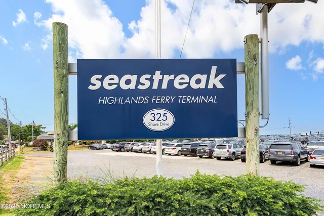 a view of a street with cars parked on road