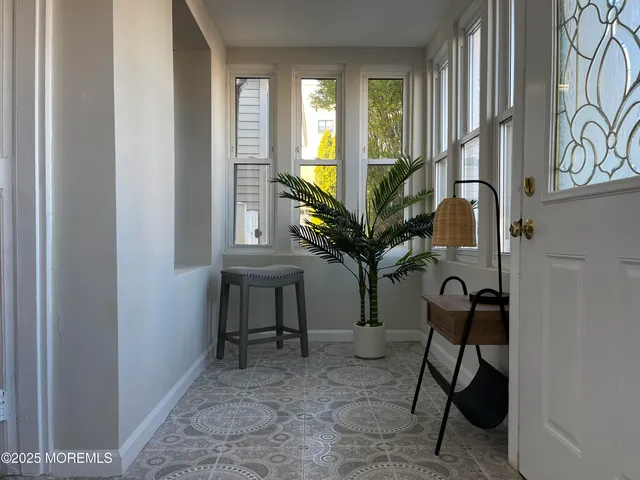 a view of an entryway with a potted plant on a table