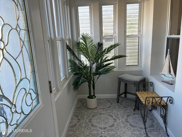 a view of balcony with furniture and a potted plant