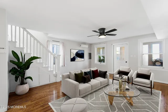 a living room with furniture potted plant and a window